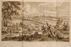 Offenes Buch mit der Aufschrift 'Ansicht der Schlacht von Castellum und Castellium aus der Illustrated London News', das eine Landschaft mit einer Gruppe von Menschen im Vordergrund, Bäumen, Pflanzen, Gebäuden im Hintergrund und Wolken am Himmel zeigt.