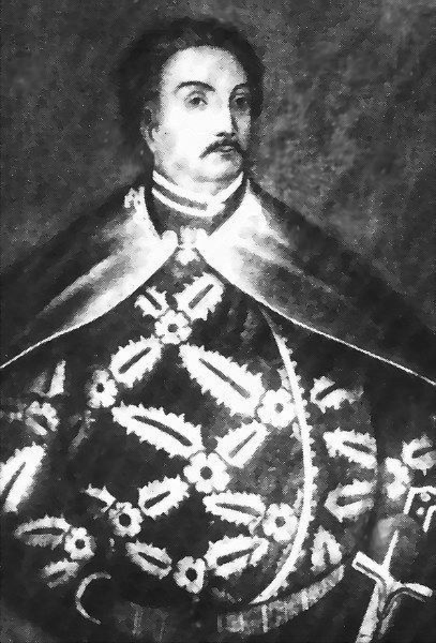 Schwarzes und weißes Foto von Papst Johannes Paul II. in Priesterrobe, der eine schwarze Robe mit weißem Kragen und Manschetten trägt und mit ernstem Gesichtsausdruck und direktem Blick dasteht.