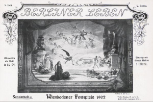 Ein Schwarz-Weiß-Foto einer Bühne der Wiesbadener Festspiele 1902, das Menschen in traditioneller deutscher Kleidung zeigt, einige mit Hüten und andere mit Umhängen, unter bunten Lichtern und Dekorationen, während das Publikum im Hintergrund jubelt.